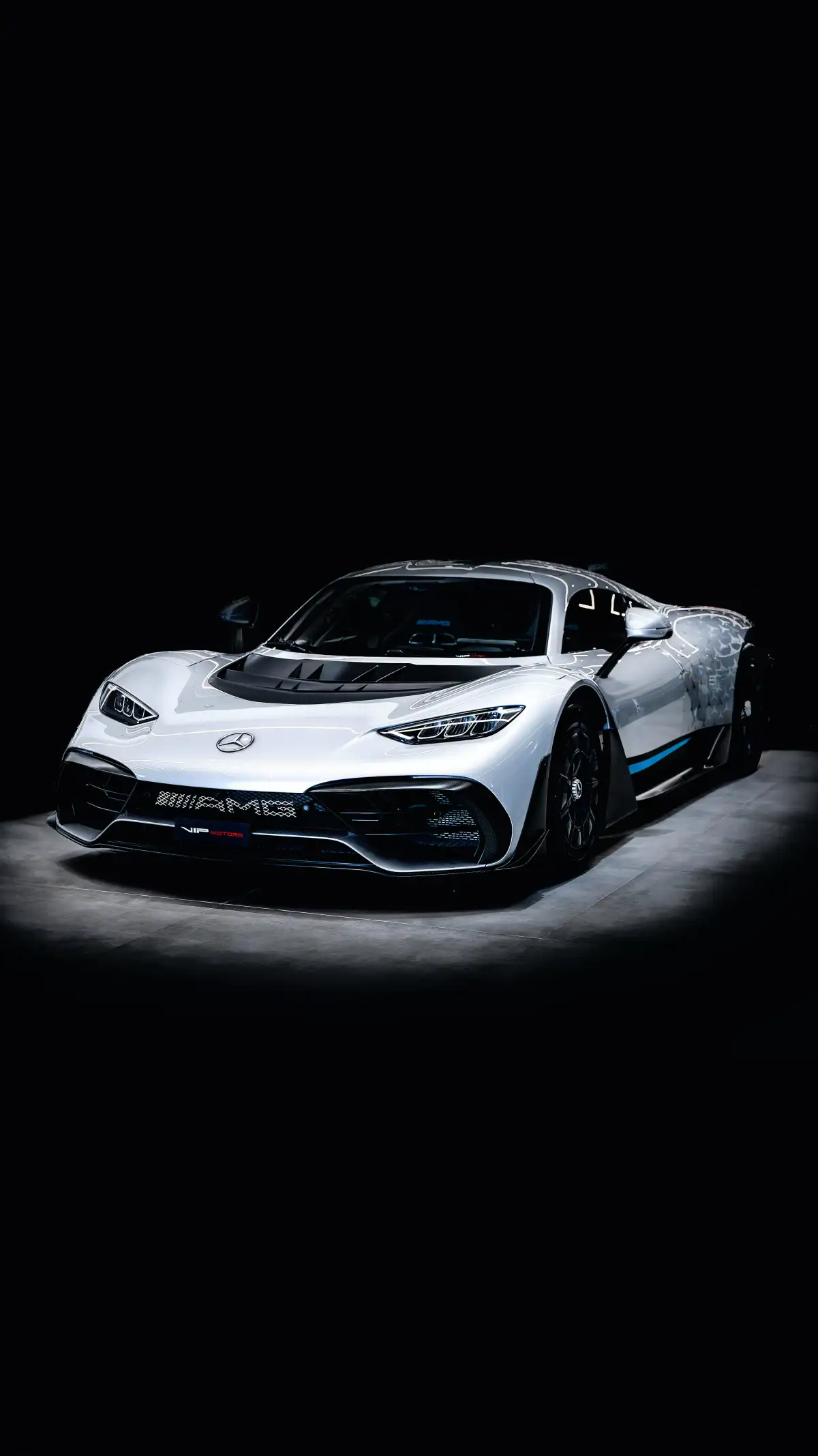 a white sports car in a dark room